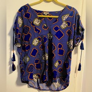 Fun summery tasseled shirt w/ geo-shape pattern. Blue, gold & white colors.